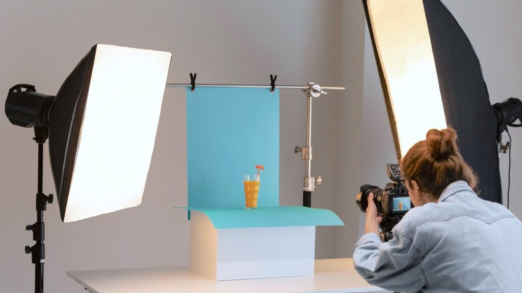Woman shooting a product photo with softbox lighting