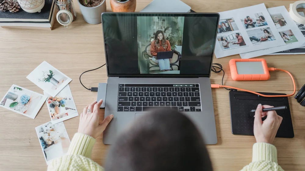 A person doing photography editing on a laptop